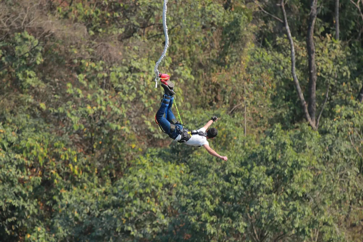 A bungee jumper leaping from the platform near Rishikesh