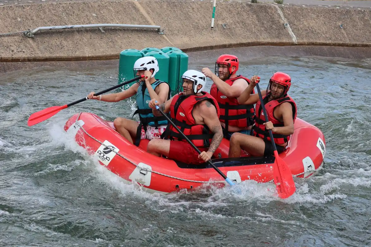 A rafting team paddling through a Ganga rapid, Rishikesh