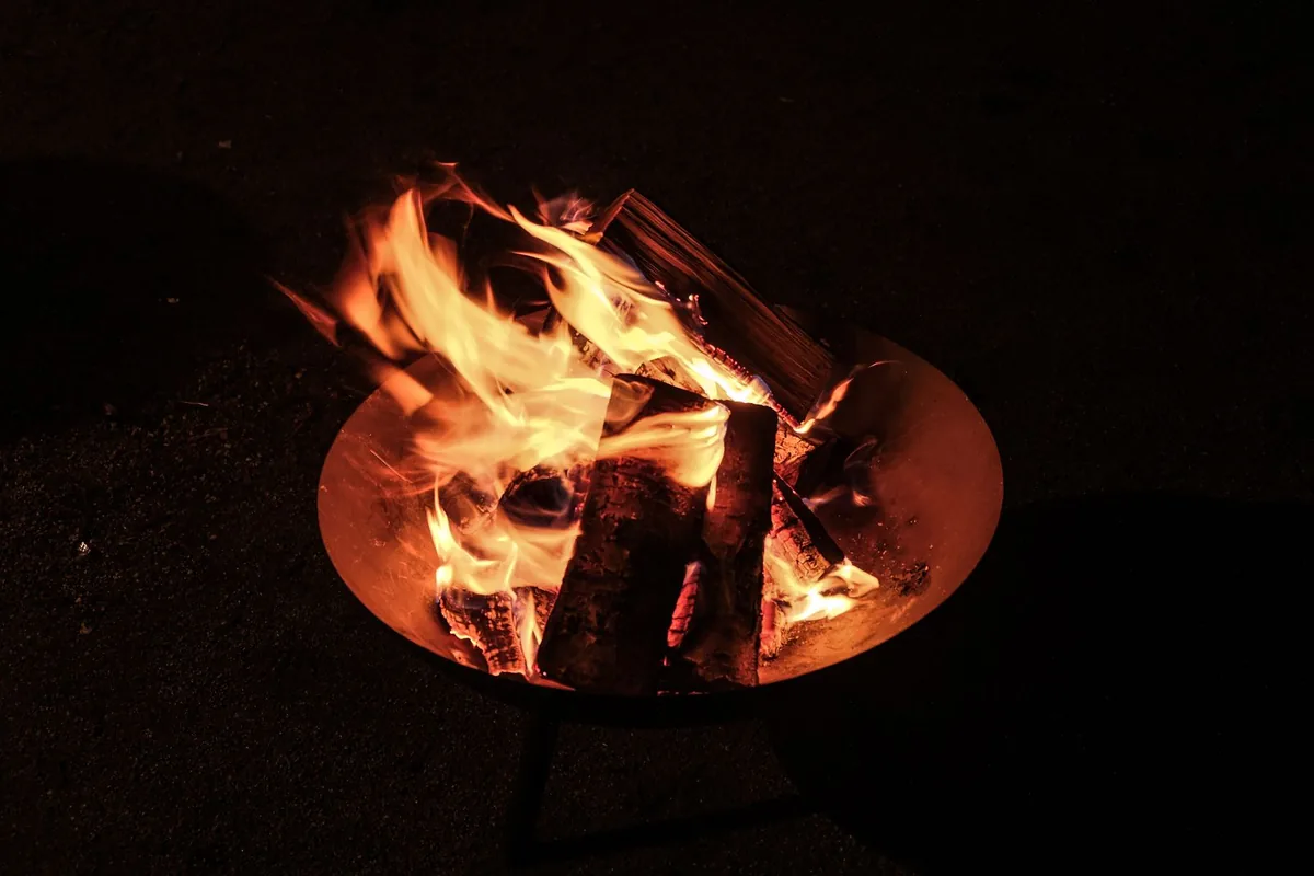 Bonfire at a riverside camp at night, Rishikesh